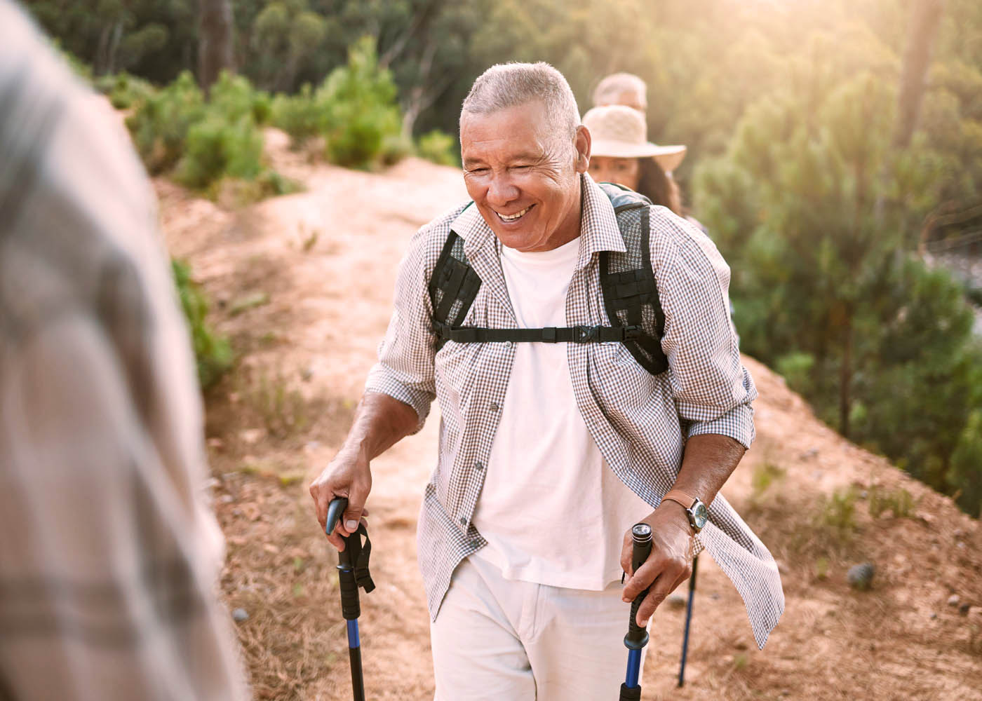 An older man hiking and enjoying the increased energy of red light weight loss in Lehi, UT.