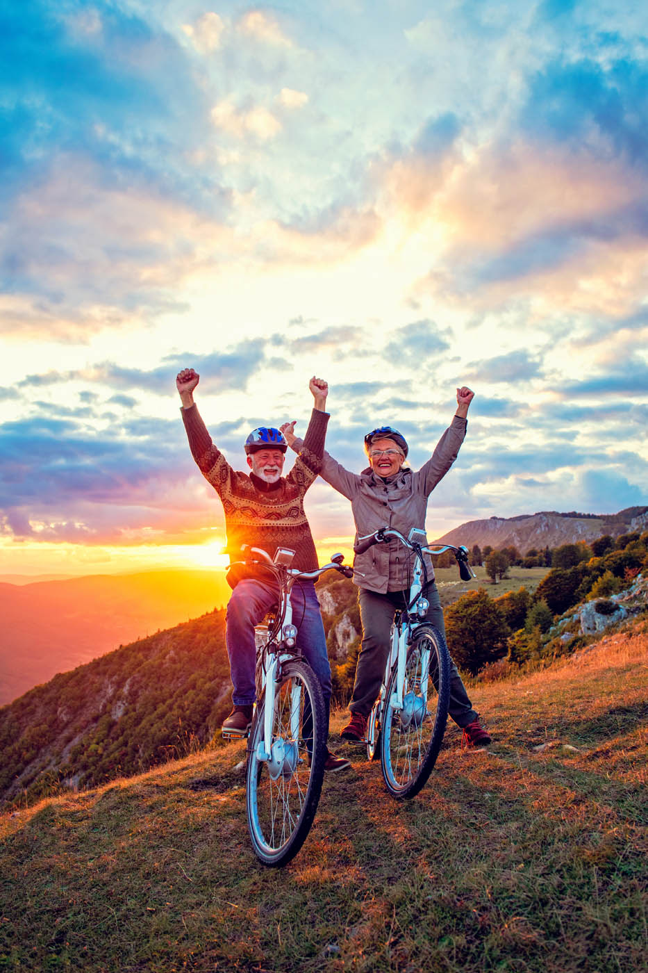 A senior couple biking pain-free into the sunset thanks to Light Lounge's knee pain treatment in Scottsdale